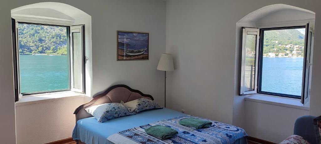 Bedroom at Villa Kamena with two windows opening to the Bay of Kotor