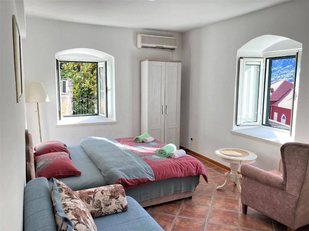 Spacious apartment at Villa Kamena with bed, sofa and arched windows