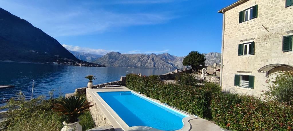 Pool terrace and stone building at Villa Kamena beside the Bay of Kotor